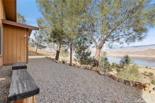 view of yard featuring a water and mountain view