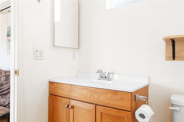 bathroom with toilet and vanity