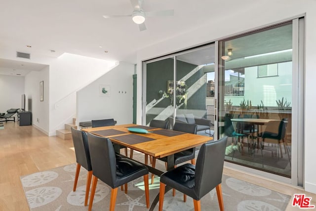 dining area featuring light wood-type flooring and ceiling fan