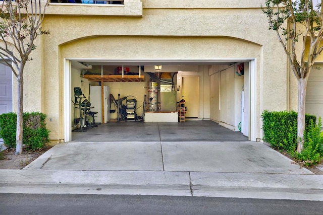 view of exterior entry with a garage and heating unit