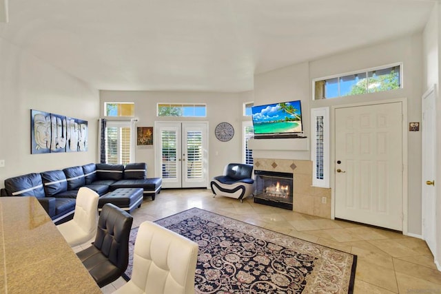 living room with light tile patterned floors, french doors, and a fireplace