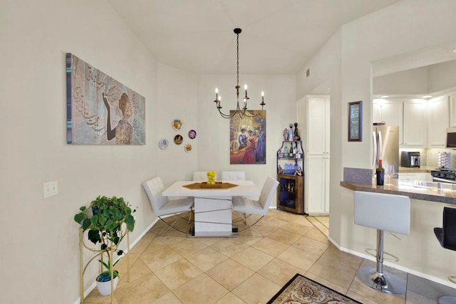 tiled dining room featuring an inviting chandelier