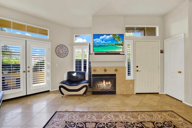 tiled entryway featuring a tile fireplace and french doors