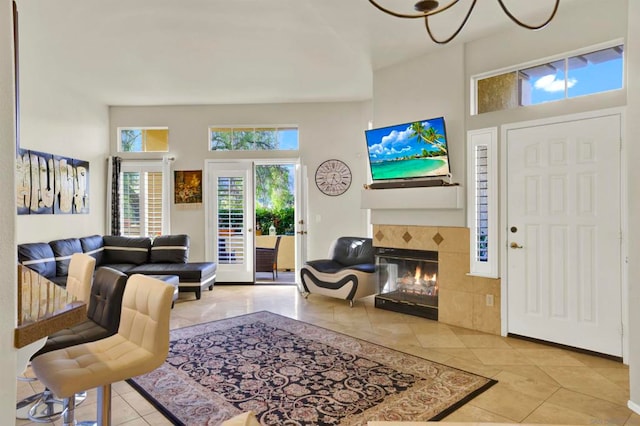 tiled entrance foyer featuring a high ceiling and a tile fireplace