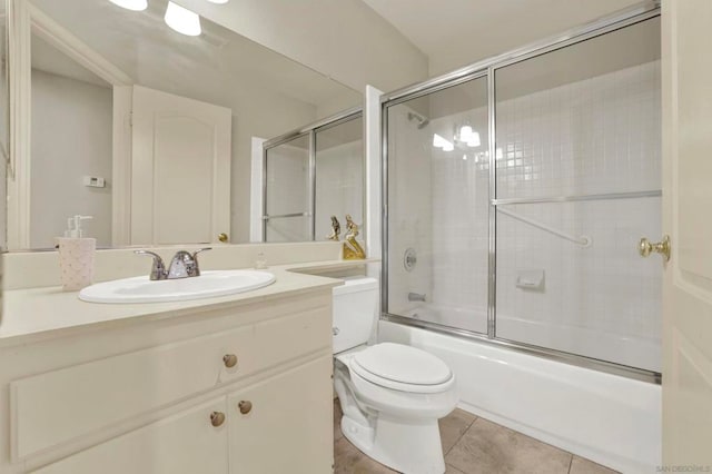 full bathroom with toilet, tile patterned flooring, enclosed tub / shower combo, and vanity