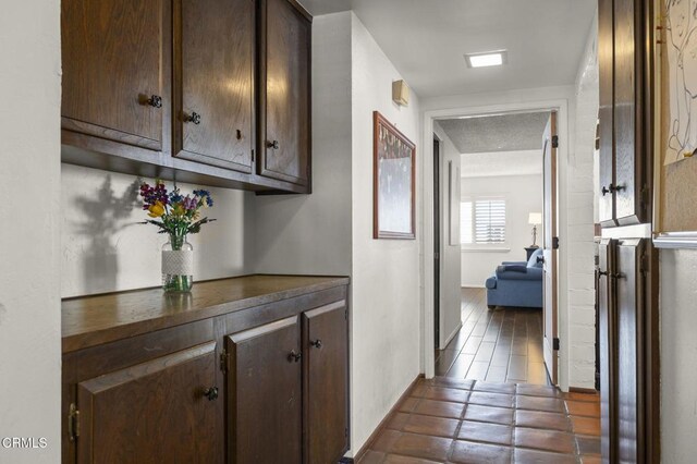 corridor with dark tile patterned flooring