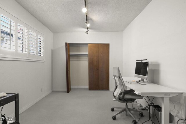 office with a textured ceiling and rail lighting