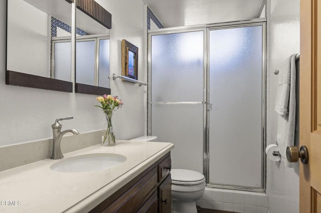 bathroom with walk in shower, vanity, and toilet