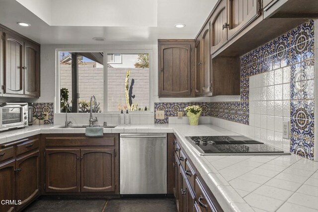 kitchen featuring dishwasher, tile counters, decorative backsplash, sink, and dark brown cabinets