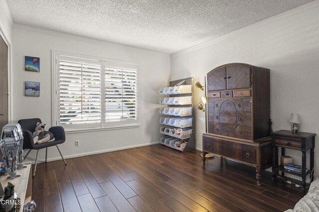 living area with dark wood-type flooring, crown molding, and a textured ceiling