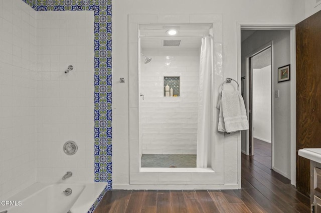 bathroom with wood-type flooring and shower / bath combination with curtain