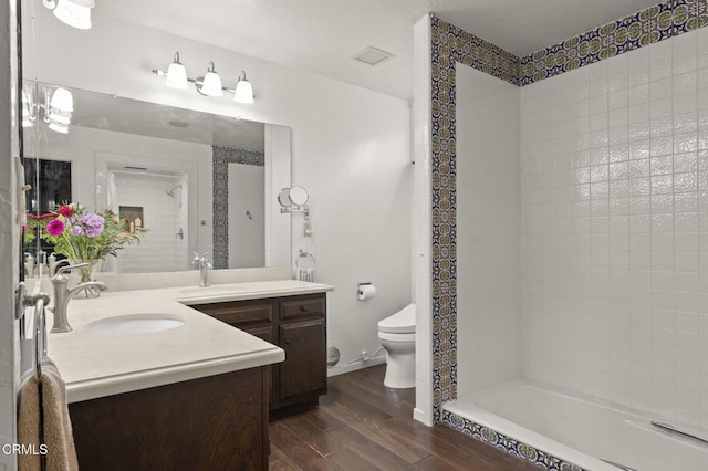 bathroom with toilet, vanity, and hardwood / wood-style flooring