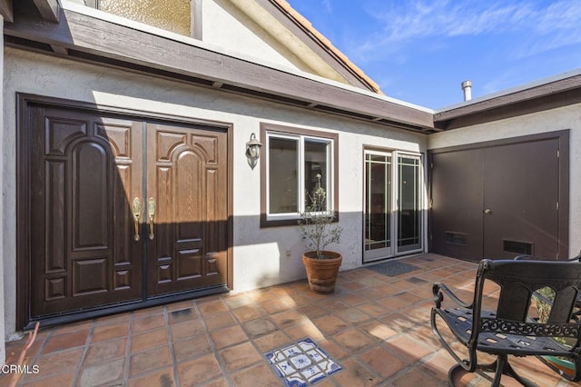 entrance to property with a patio area