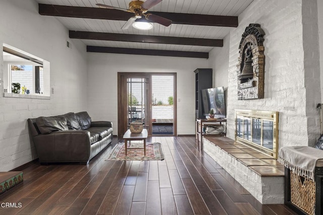 living room featuring ceiling fan and beamed ceiling