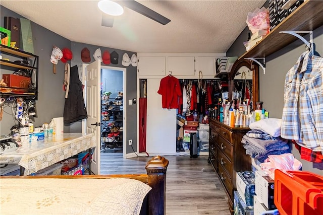 interior space featuring a textured ceiling, ceiling fan, and hardwood / wood-style flooring