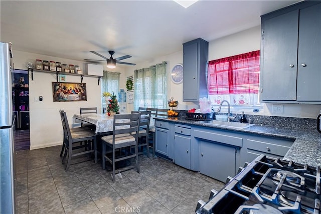 kitchen with ceiling fan, stainless steel fridge, and sink