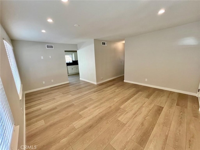 unfurnished living room featuring light hardwood / wood-style floors