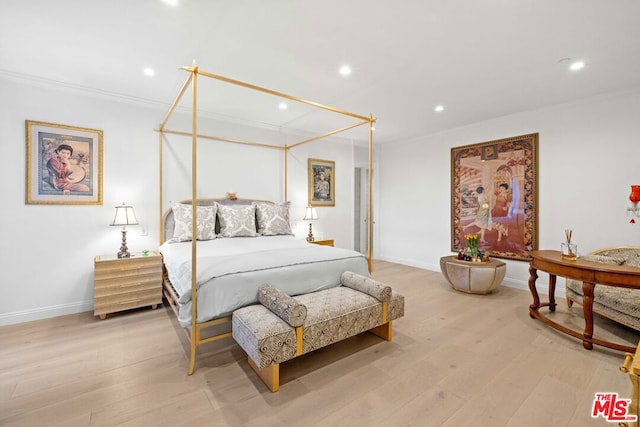 bedroom with light wood-type flooring and crown molding