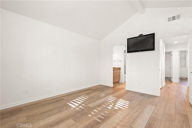 interior space featuring light hardwood / wood-style flooring, beamed ceiling, and high vaulted ceiling