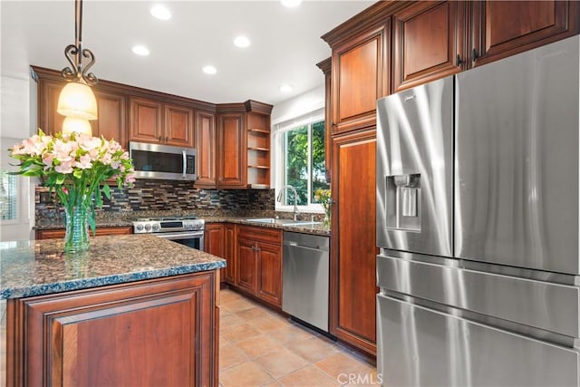 kitchen with pendant lighting, stainless steel appliances, decorative backsplash, sink, and light tile patterned floors