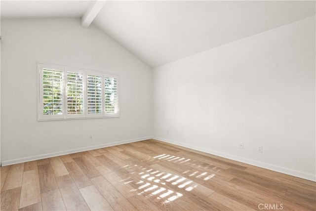 spare room with light hardwood / wood-style floors and vaulted ceiling with beams