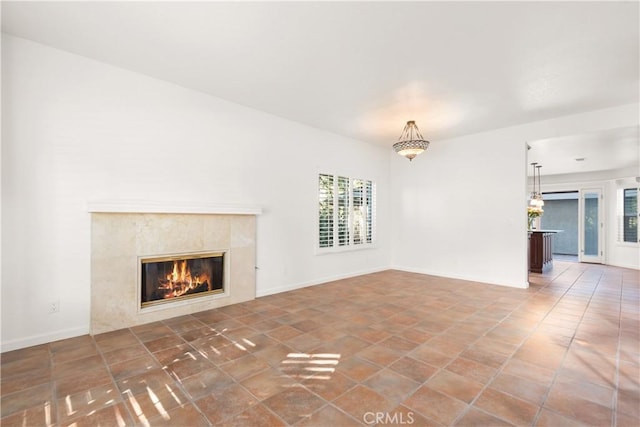 unfurnished living room featuring a premium fireplace