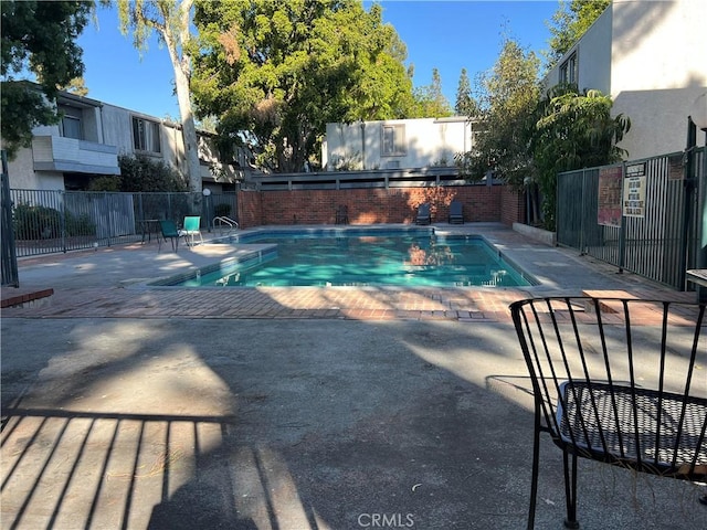 view of swimming pool with a patio