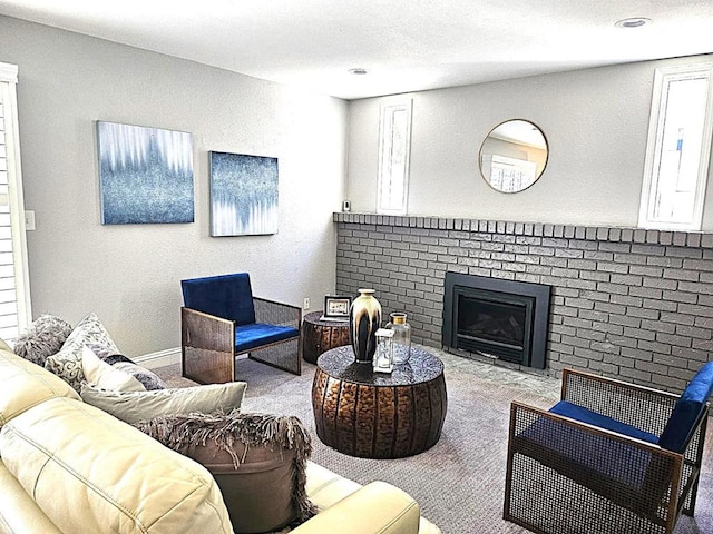 carpeted living room featuring a fireplace