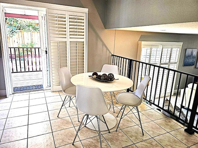 dining room featuring plenty of natural light and light tile patterned floors