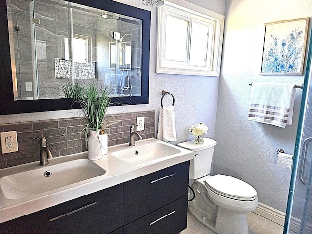 bathroom with toilet, decorative backsplash, a shower with door, and vanity