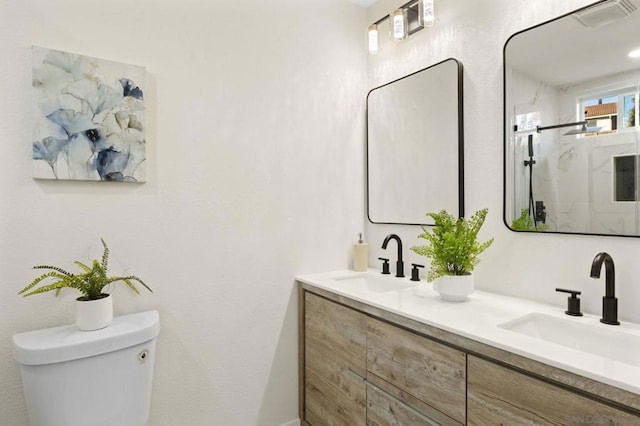 bathroom with a shower with door, toilet, and vanity