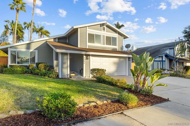 view of front of house with a front yard and a garage