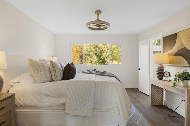 bedroom with dark wood-type flooring