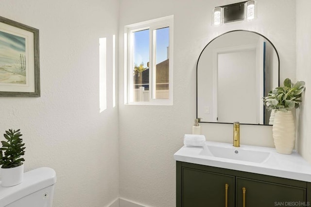 bathroom featuring toilet and vanity