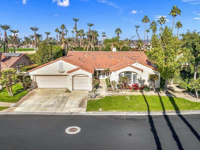 mediterranean / spanish-style home with a garage and a front yard