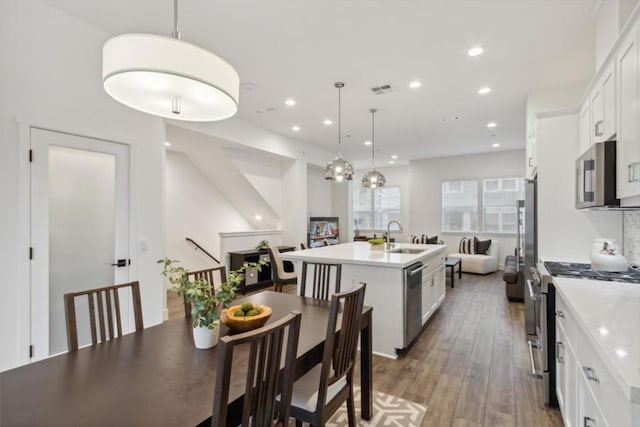 dining area featuring sink and hardwood / wood-style floors