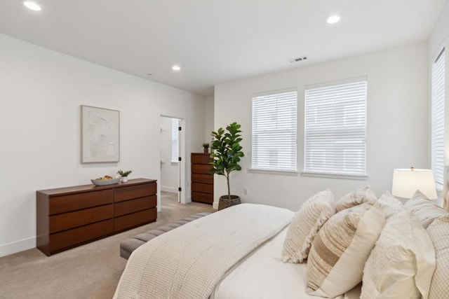 carpeted bedroom featuring multiple windows