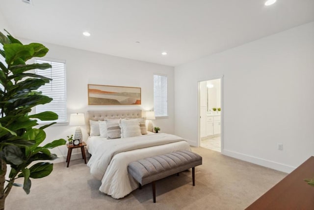 carpeted bedroom with ensuite bath