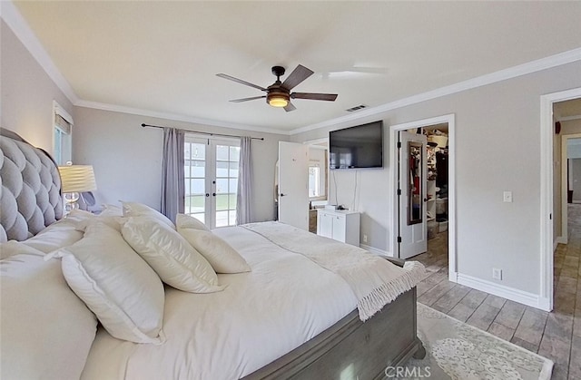 bedroom featuring ceiling fan, french doors, a spacious closet, and crown molding