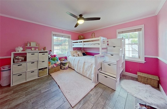 bedroom with ceiling fan and crown molding