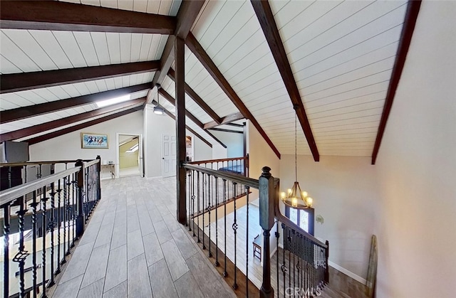 corridor with wooden ceiling, a chandelier, wood-type flooring, and vaulted ceiling with beams