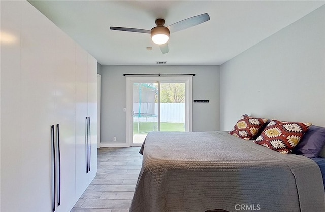 bedroom featuring ceiling fan, light hardwood / wood-style floors, and access to outside