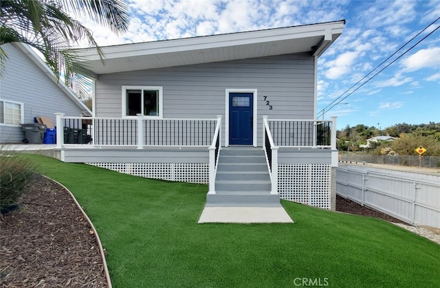 rear view of property with a yard