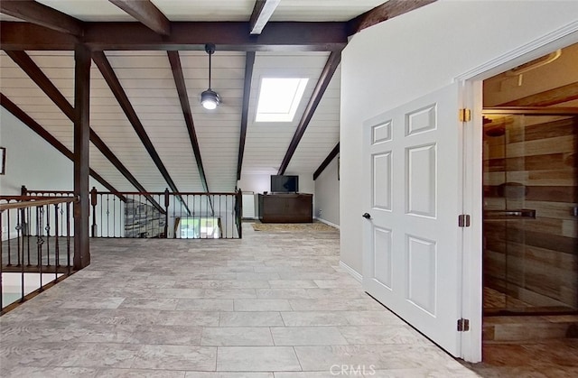 corridor with vaulted ceiling with skylight