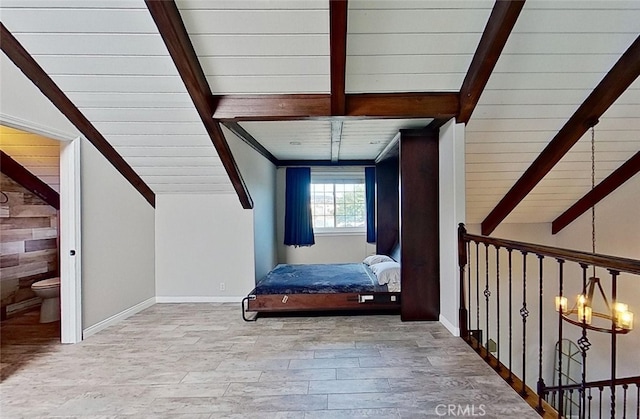 interior space with a chandelier, light hardwood / wood-style floors, and lofted ceiling with beams