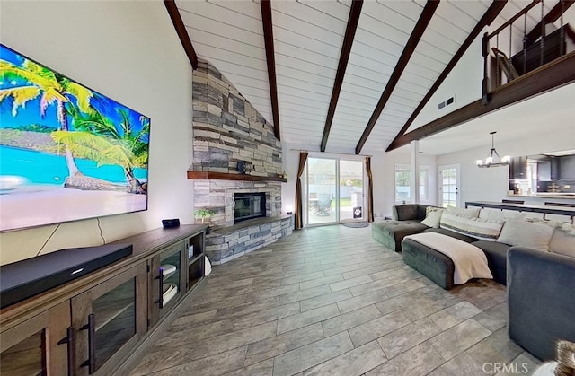 living room with high vaulted ceiling, a fireplace, beamed ceiling, and an inviting chandelier