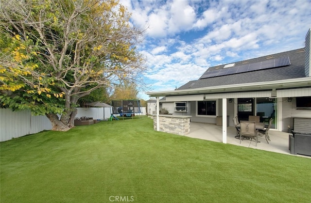 view of yard featuring a trampoline and a patio