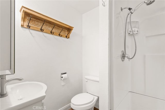 full bath featuring walk in shower, toilet, and a sink