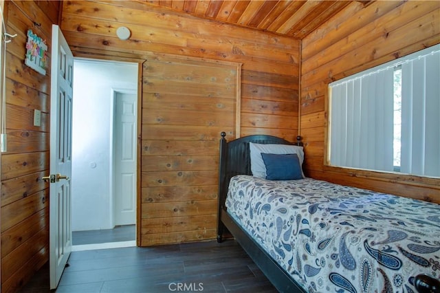 bedroom featuring wood finished floors, wooden ceiling, and wooden walls