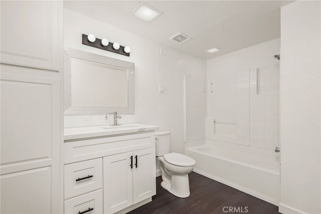 bathroom with wood finished floors, visible vents, toilet, vanity, and tub / shower combination